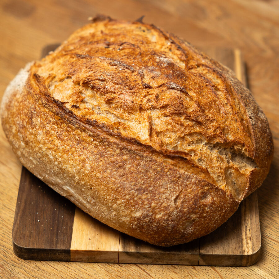 A sourdough loaf on a wooden board.